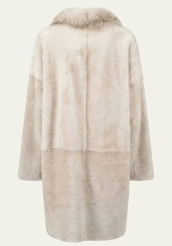 Cream women’s sheepskin coat shown from the back with a straight cut and hood.