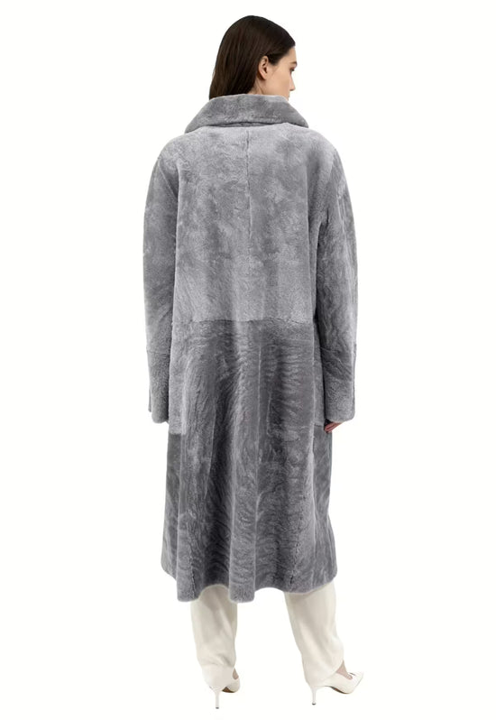 Grey women's sheepskin coat in curly sheepskin shown from the back on a model