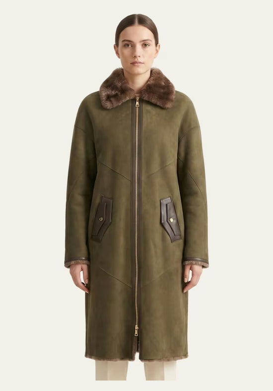Ladies' sheepskin coat in olive worn on a model, closed at the front with a soft sheepskin collar.