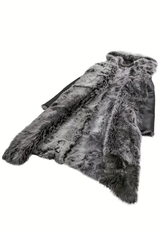 Black women's sheepskin coat with grey curly sheepskin lining, shown laid flat from an angled view