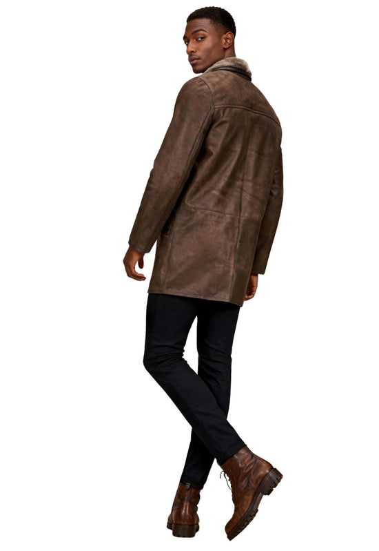 Men's sheepskin coat in chocolate shown on the model from a side rear view with smooth leather finish.