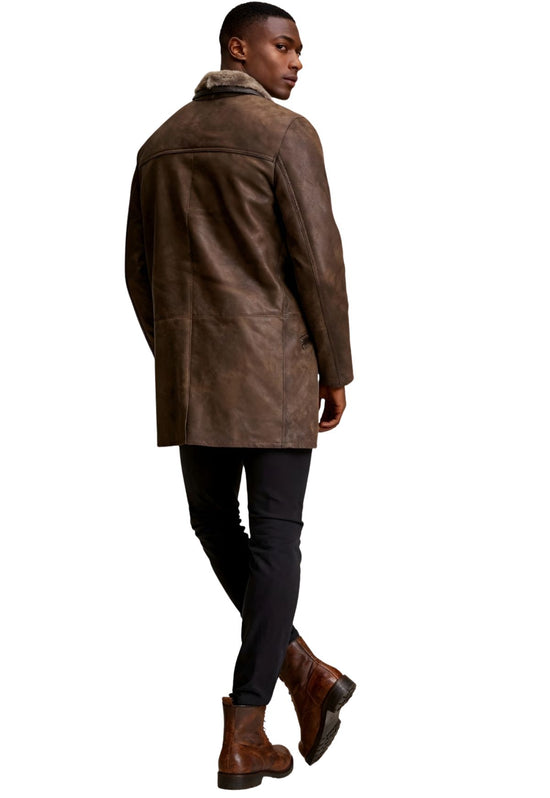 Men's sheepskin coat in chocolate worn from the back, showing the rear panel and leather detail.