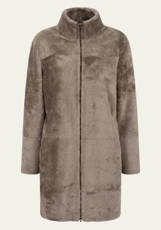 Grey-brown women’s sheepskin coat shown front-on in the fur side, with short stand collar and full zip.