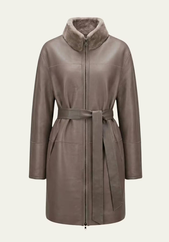 Grey-brown women’s sheepskin coat shown front-on in the smooth leather side with stand collar and belt.