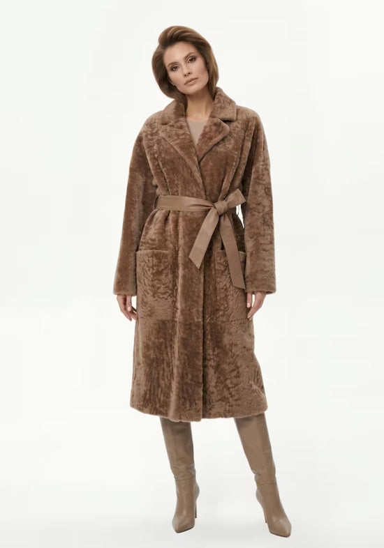 Long women’s shearling sheepskin coat in cappuccino, worn in a front view