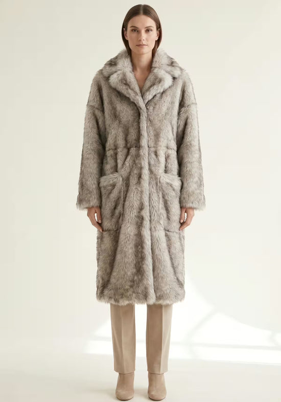 Women’s sheepskin coat made of Toscana sheepskin in frost grey, worn full length with pocket detail.