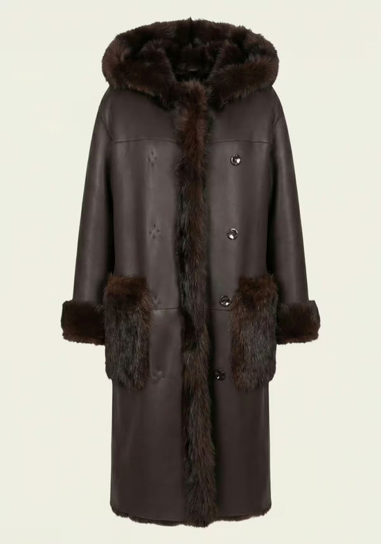 Brown reversible sheepskin coat for women with button fastening, hood and patch pockets.