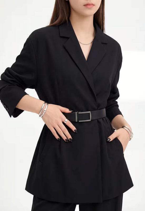 Women's leather belt made of buffalo leather in black at the waist of a black outfit.