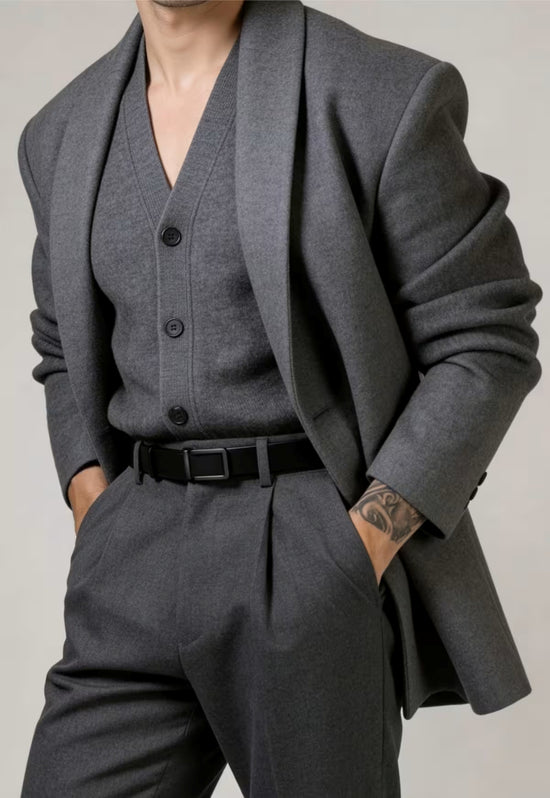 Men's leather belt made of buffalo leather in black, worn with a grey suit.