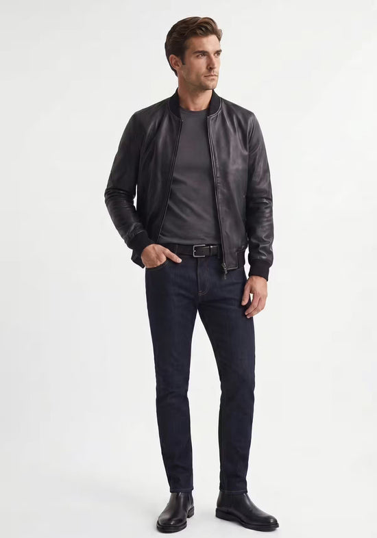 Men's leather jacket in black lamb nappa leather on a model, with stand collar, zip and slim fit.