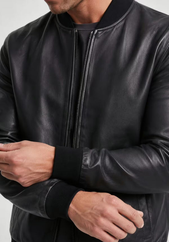 Detail of the men's leather jacket in black lamb nappa leather with zip, cuff and smooth surface.