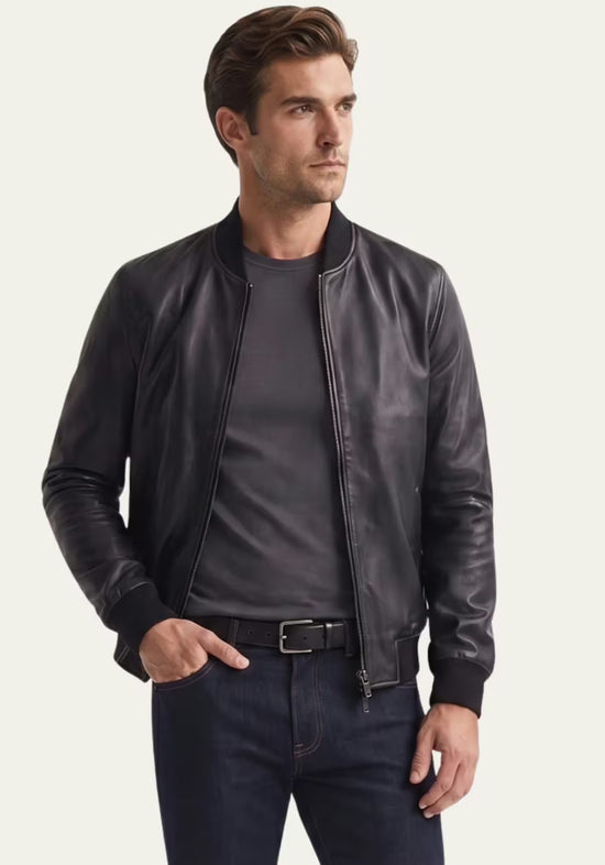 Men's leather jacket in black lamb nappa leather shown in a half-length view on model, side with zip closed.