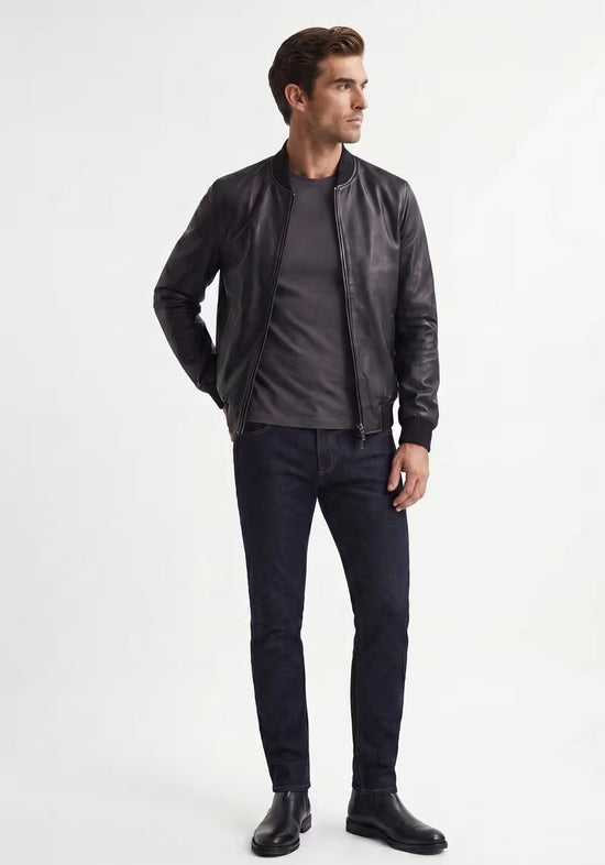 Men's leather jacket in black lamb nappa leather on a model in side view with a slim cut.