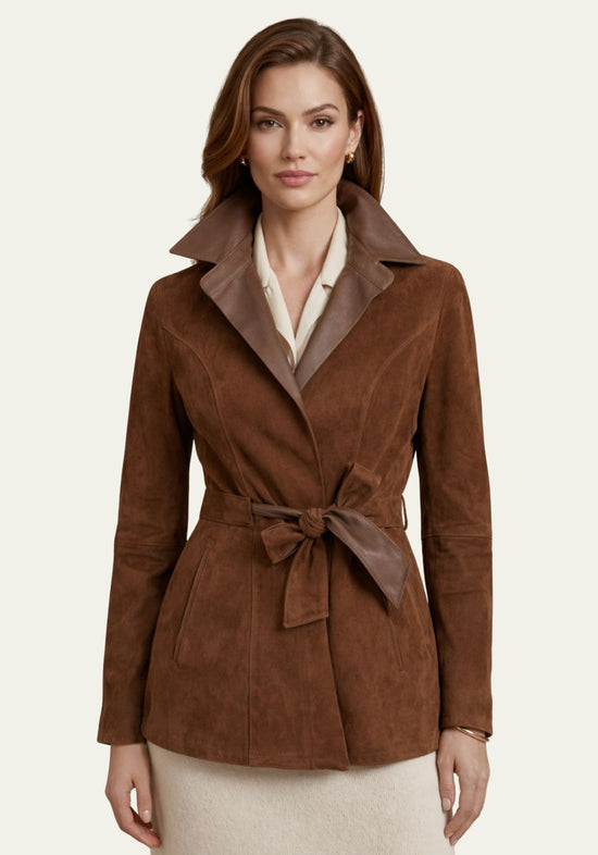 Brown women's leather jacket in suede, worn on the model from the front with tie belt and lapels.