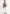Beige men's leather jacket in suede shown full length with white trousers