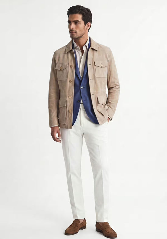 Beige men's leather jacket in suede shown full length with white trousers