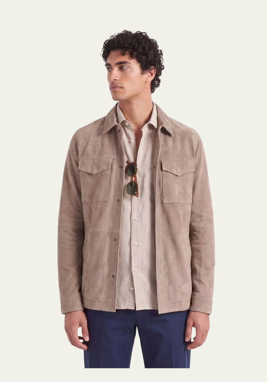 Men's suede leather jacket in beige, worn open with shirt and sunglasses