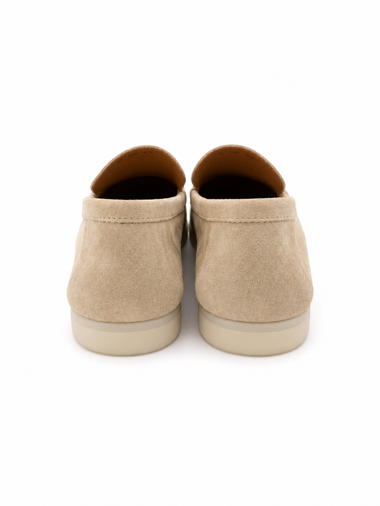 Rear view of two beige men's loafers in calf suede with flat soles.