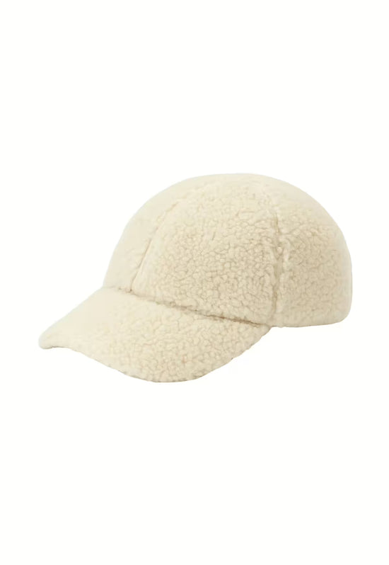 Freestanding cream sheepskin cap with a curved brim and soft texture.