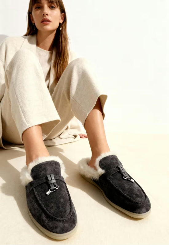 Women's sheepskin mules in anthracite worn on foot, with white fur trim and dark sole.