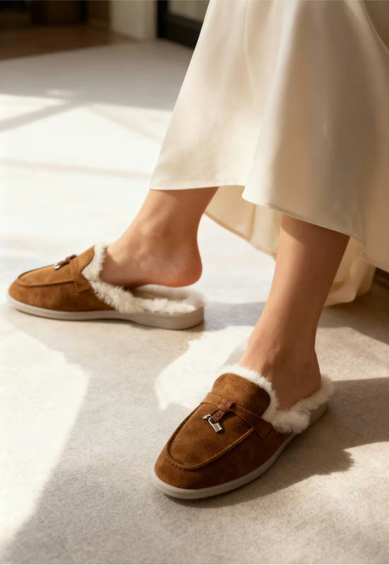 Brown ladies' sheepskin mules worn on the feet, with open heel and white sheepskin lining.