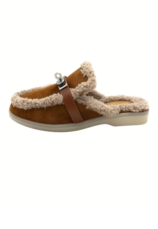 Brown women's sheepskin mules shown from the side with trim and buckle.