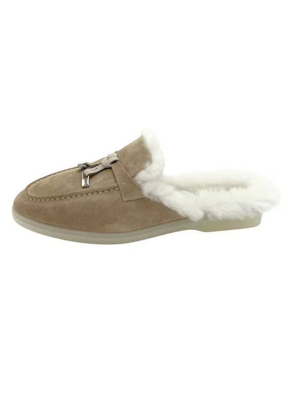 Women's sheepskin mules in sand with a side view and white sheepskin lining.
