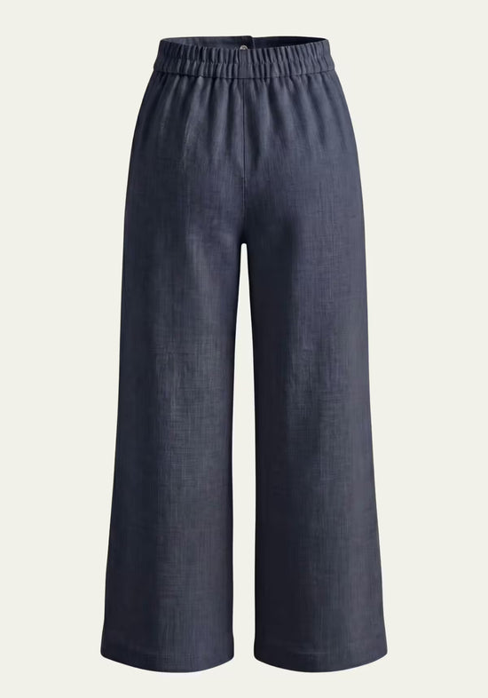 Blue women’s linen palazzo trousers with an elastic waistband and wide, loose legs.