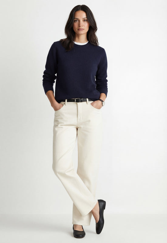 Dark navy cashmere jumper worn by a woman, with a neat crew neck and long sleeves.