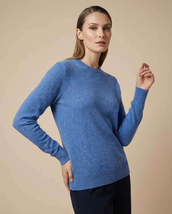 Women's light blue cashmere sweater shown worn on a model in a slight front angle.