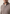 Close-up of the men's merino wool pullover in taupe, showing the zip at the stand-up collar and knit texture.