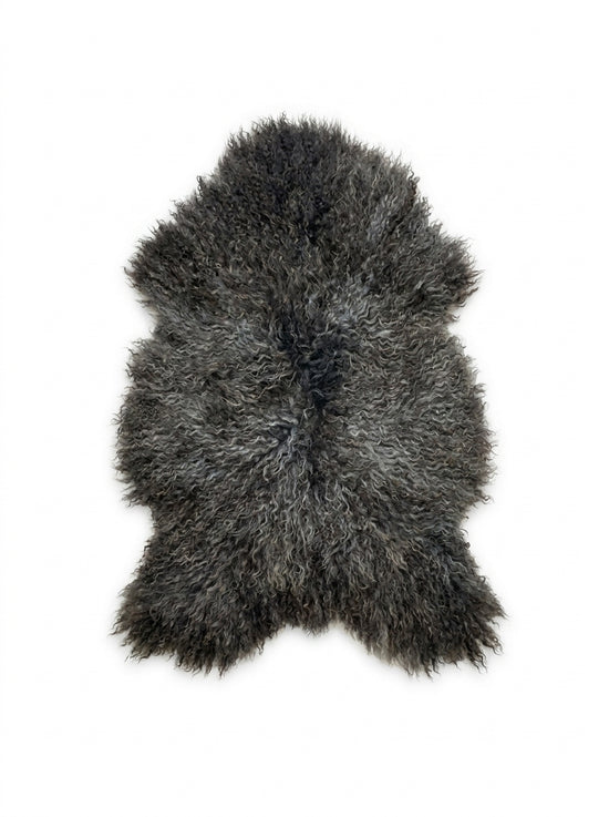 Grey Gotland sheepskin with a curly pile, cut out on a white background.