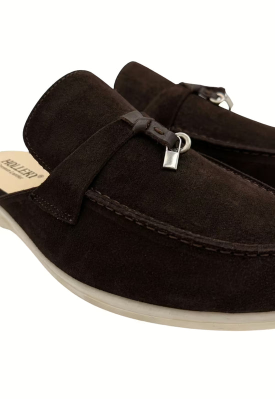Close-up of a men's suede slipper in brown with tassel and stitching on the vamp.