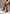 Brown women's suede boots worn on the leg, with a side zip and block heel.