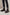 Dark brown men’s sheepskin ankle boots in leather, worn with turned-up jeans.