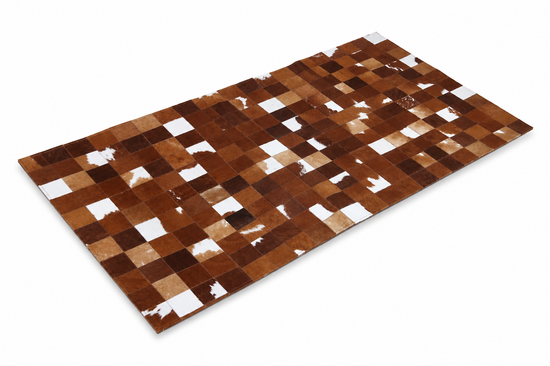 Cowhide rug with brown and white patchwork look shown isolated from above