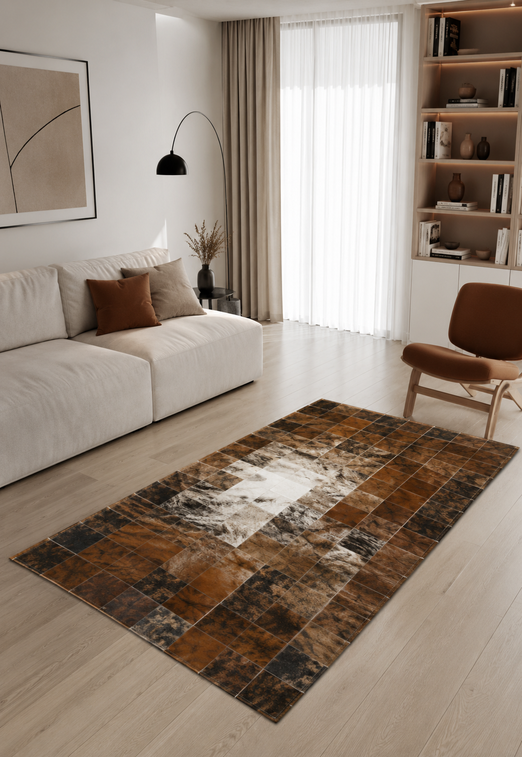Cowhide rug in brown, white and black shown in a modern living room setting.