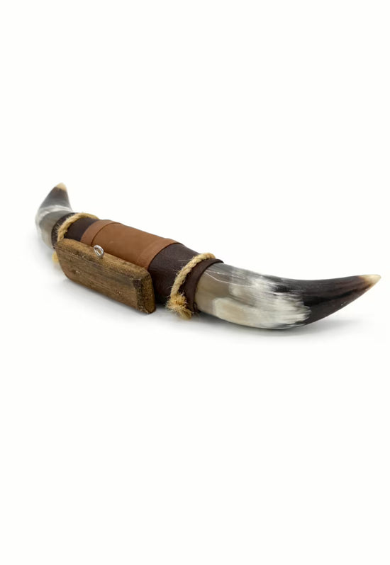 Wall decoration made of natural horn with leather and wood holder, angled side view on a white background.
