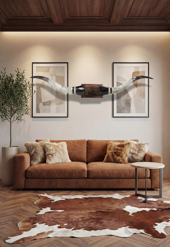 Black leather wall decoration with longhorns above a sofa in a living room.