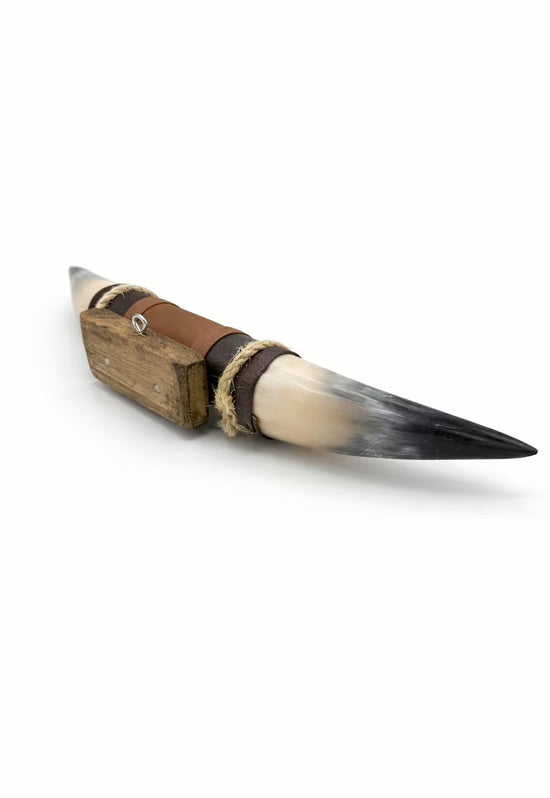 Wall decoration made of natural horn with leather and wooden bracket, shown in side view on a white background.