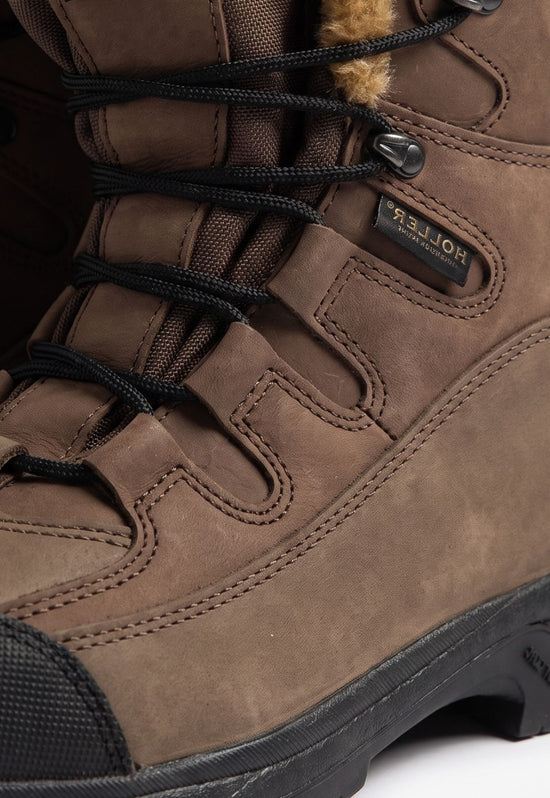 Detail of the brown sheepskin hiking boot with lacing, stitching and a black toe cap.
