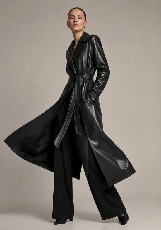 Angled view of the women’s wrap coat in black-brown lamb nappa leather with a flowing hem.
