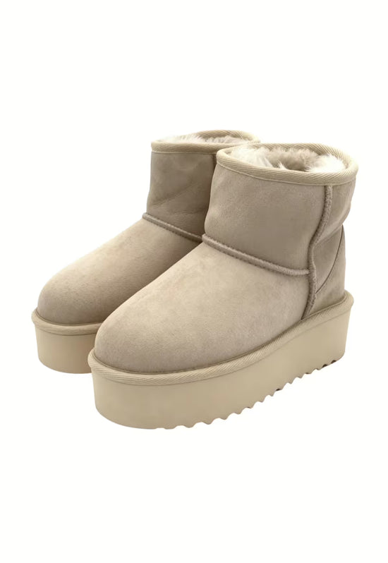 Beige women's winter boots in sheepskin shown as a pair on a white background