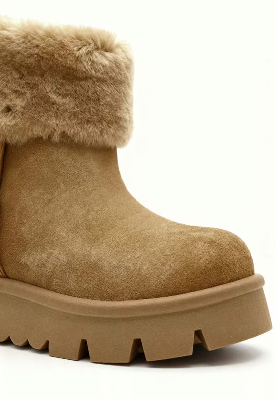 Women's brown shearling winter boot with a wide sole and soft shaft detail