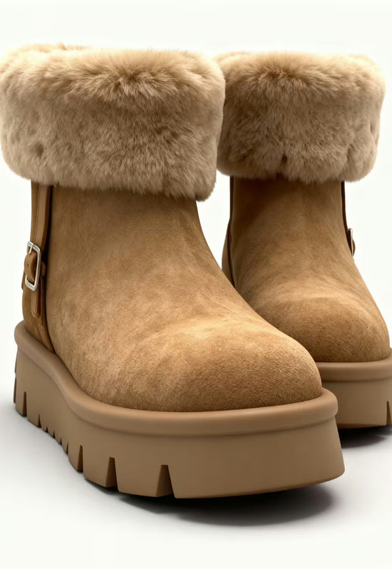 Women's brown shearling winter boots in an angled view with a tread sole