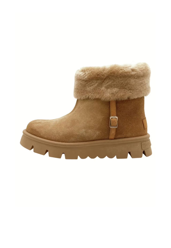 Women's winter boots in brown shearling shown from the side with a wide fur cuff