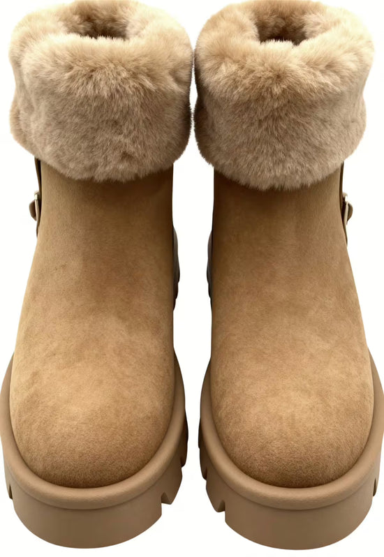 Women's brown shearling winter boots in front view with fur cuff and rounded toe