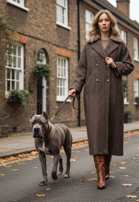 Brown women's wool coat with texture and belt, worn outdoors in a full-length view.